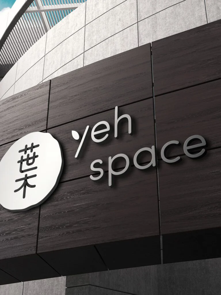 Yeh Space logo sign on a dark timber building facade